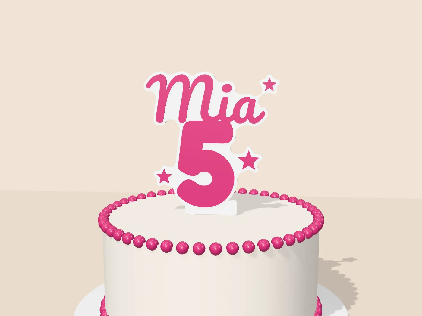 Pink and white 3D printed cake topper reading Mia 5 on a birthday cake