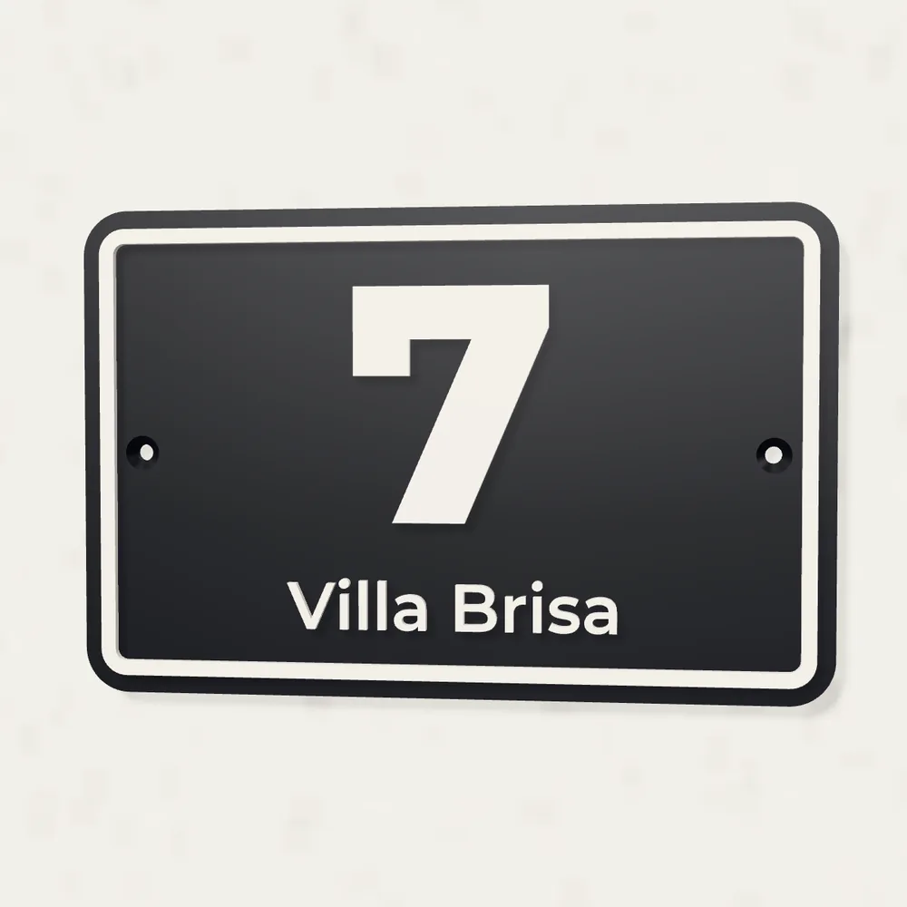 Black house number 7 plaque reading Villa Brisa